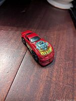 Top view showing red car body with Roman's Pit Stop design