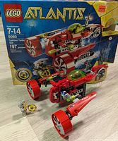 Photo of LEGO Atlantis 8060 box set with assembled red submarine featuring two large turbine fan engines and green cockpit. Includes small accessory piece.
