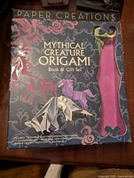 Box cover photo showing 'Paper Creations Mythical Creature Origami Book & Gift Set' with origami art of mythical creatures