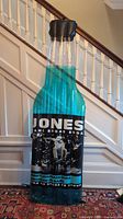 Front view of rare Jones bottle inflatable showcasing detailed bottle label and blue liquid color inside.
