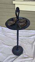 Full view of the vintage blue ash tray stand showing twisted metal stem, circular base, and four ash trays with central handle.