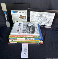 Photo of the complete set showing the cover of the Itoya Art ProFolio book, Strathmore sketchpad, and the stacked art drawing books.