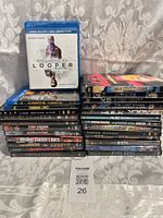 Stacks of DVD and Blu-ray movies showing titles and cases condition