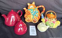 Four novelty vintage ceramic teapots with distinct shapes and themes.