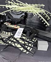 Overview of race car set contents including track pieces, support rails, two cars, controllers, and power adapter