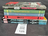 Pile of six Star Wars books stacked horizontally, titles visible on book spines.
