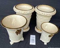 Four vintage ceramic planters: two large textured with gold leaf rims and bases, two smaller with smooth finish and gold decorations.