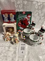 Full lot showing two Calico Cat figurines, ornaments in boxes, Disney plastic figures, Christmas DVD, and two decorated Partylite snowmen candle holders with wear.