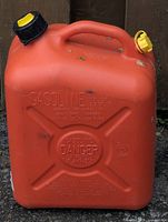Front view of red gasoline jerry can showing embossed warning text and capacity information.