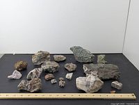 Photo showing the full set of approximately 17 rocks and stones arranged.