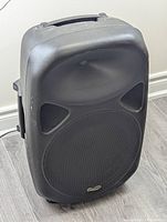 Front angled view of the Ion Total PA speaker showing the large woofer and horn tweeter.