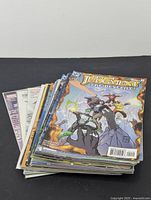 Stack of comic books viewed from side showing multiple issues piled