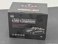 Box for the car camera showing branding, HD label, and automobile image.
