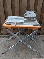 Table saw mounted on folding stand in outdoor setting