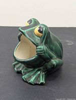 Front view of green ceramic frog with open mouth for sponge or soap
