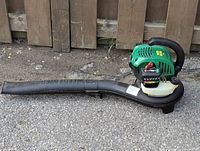 Gas powered green and black Weed Eater leaf blower showing whole unit with nozzle attachment and fuel tank.