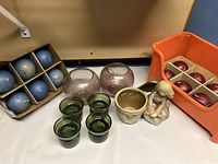 All items shown together including glass candle holders, ceramic angel planter, and candles in boxes.