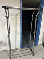 Front view of chrome clothes rack showing structure and base