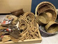 Image showing large wooden tray with multiple rolls of twine, thick knotted rope strands, and several tied natural twig miniature brooms.
