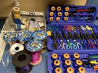 Fiskars scissors, punches, and ribbon with crafting supplies grouped on surface