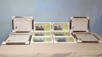 Lot of twelve frames including six 6x12 inch photo frames with class and individual photos displayed and six 11x14 inch certificate frames with Certificates of Excellence, all in white plastic and in packaging.