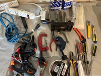 Full lot overview showing all items including clamps, vice, screwdrivers, cutters, extension cord, power bars, and hardware.