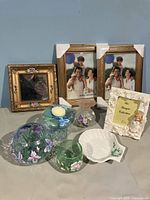 Photo showing two gold painted 8x10 frames, smaller ornate square mirror with handpainted flowers, perfume bottle, ceramic soap dish, various painted glass vases and candle holder, and a ceramic fairy frame.