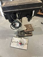 Full view of Jobmate drill press with base and adjustable table.