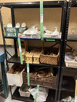 Front view of one black metal shelving unit displaying shelves with various items (not included).