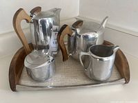 Full set placed on tray showing coffee pot, tea pot, cream pitcher, sugar bowl, and tray.