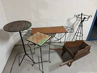 Overview of all five plant stands including the wheelbarrow, showing arrangement and condition