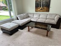 Full room view showing L-shaped sectional sofa with ottoman and coffee table (table not included)