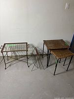 Full view capturing all items: brass and glass side table, metal magazine holder, and two wicker nesting tables.