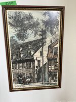 Full view of the framed watercolour showing Rue du Tresor street scene with buildings, trees, and horse carriage.