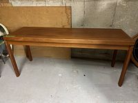 Full view of wooden sofa table showing length, legs, and finish