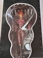 Front view of the ATI Agent Ruby figure in closed box with clear plastic window showing entire figure dressed in maroon outfit.