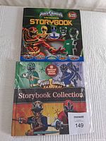 Two vintage hardcover Bandai Power Rangers storybooks stacked, showing covers with colorful Power Rangers illustrations and text indicating story collections.