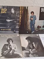 Four Billy Joel vinyl record album covers displayed together with Billy Joel featured on each.