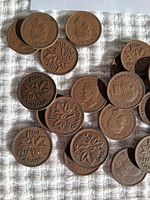 Photo showing multiple Canadian pennies from 1937 and 1938, both obverse and reverse sides visible.