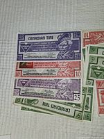 Photo showing 25 cent, 10 cent Canadian Tire money bills arranged in rows.