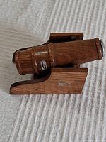 Wooden MCM style salt or pepper shaker on a matching wooden rotating stand, viewed from side angle showing details and wood grain.