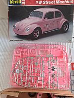 Box and sprues of pink plastic parts for VW Street Machine model kit by Revell, including chrome detail parts and stickers.
