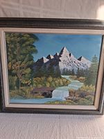 Full front view of the framed painting showing snow-capped mountains, river, trees, waterfall, and decorative frame.