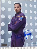 Close-up photo of signed Star Trek Enterprise photo featuring Anthony Montgomery in uniform, with blue autograph visible across front.