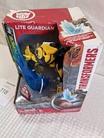 Front view of boxed Transformers Bumblebee Lite Guardian night light figure with blue energy effect and branded packaging.