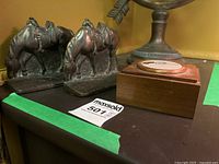 Pair of cast iron horse bookends displayed side by side on a surface with a MaxSold lot label visible