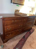 Front view of dresser showing drawer configuration and overall condition