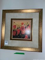 Front view of the framed floral painting featuring red poppies in a gold-tone frame with beige matting.