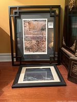 Framed photo measuring approximately 13x9 inches with geometric black frame and photo showing natural rock and earth textures.