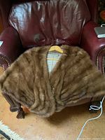 Mink fur stole front showing brown fur on a chair
